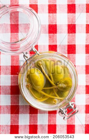 Pickled caper berries in jar. Top view