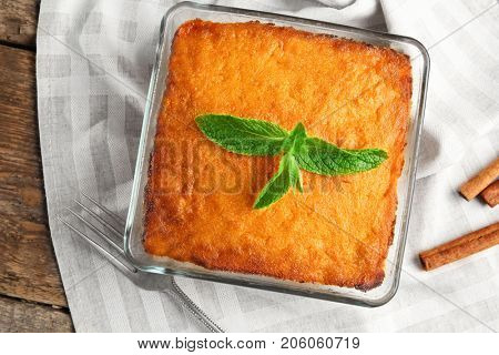 Baking dish with tasty carrot souffle on table