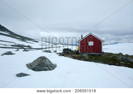 Typical norwegian red wooden house near famous Aurlandsvegen (Bjorgavegen) mountain road in Aurland, Norway in summer time