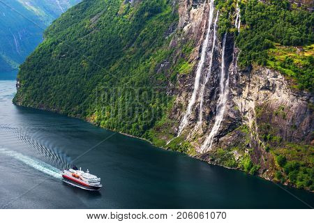 Breathtaking view of Sunnylvsfjorden fjord and famous Seven Sisters waterfalls, near Geiranger village in western Norway.