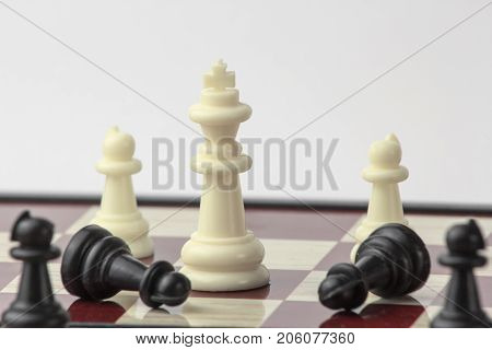 chess white queen wins pawns. concept of struggle and leadership. isolated on white background