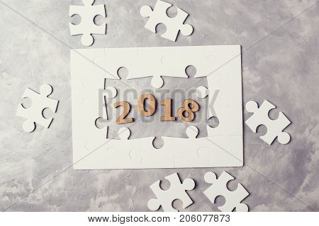 New Year Concept 2018. Jigsaw Puzzle On Grey Concrete Background.