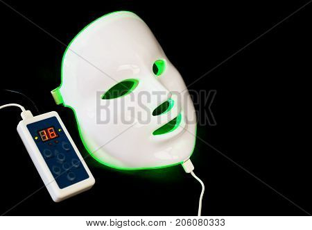Light rejuvenating mask for facial skin therapy on black background
