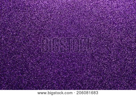 Sparkling and glittering purple background with a festive or party feel