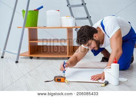 Repairman doing renovation repair in the house with paper wallpa