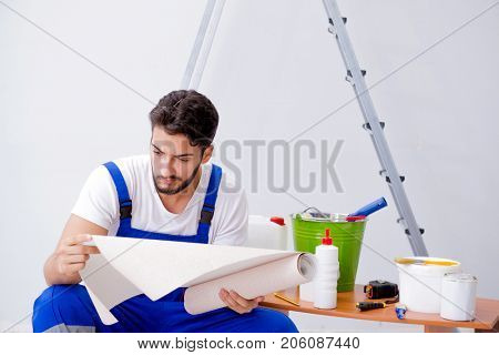 Repairman doing renovation repair in the house with paper wallpa
