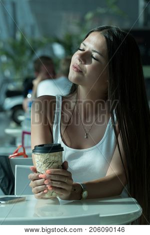Girl Is Holding A Glass Of Coffee In Airport's Business Lounge With Aircraft