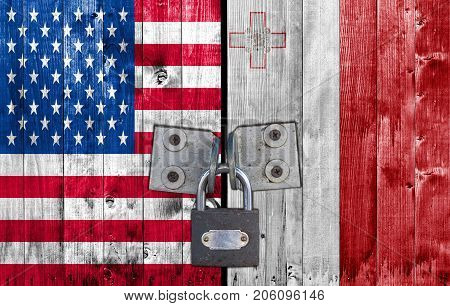US and Malta flag on door with padlock