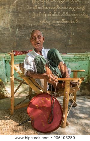 Monywa, Myanmar - Octobert 9, 2016: Portrait of an unidentified burmese old man with buddhists beads in Monywa, Myanmar
