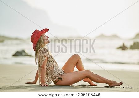 young woman relaxing on the beach in summer day
