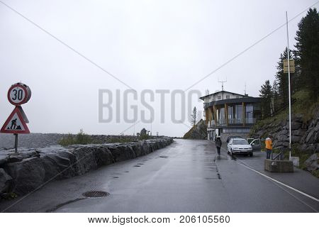 German and thai people travel and stop car for take photo on the road at Kaunertaler Glacier lake and Dam in Kaunergrat nature park on September 3 2017 in Tyrol Austria
