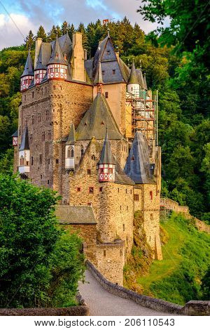 Burg Eltz castle in Rhineland-Palatinate state at sunset, Germany. Construction started	prior to 1157.