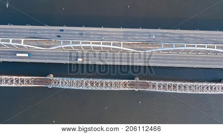 Aerial top view of bridge road automobile traffic of cars and railroad from above, transportation concept