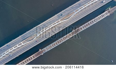 Aerial top view of bridge road automobile traffic of cars and railroad from above, transportation concept