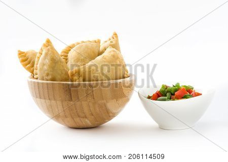 Typical Spanish empanadas in bowl isolated on white background