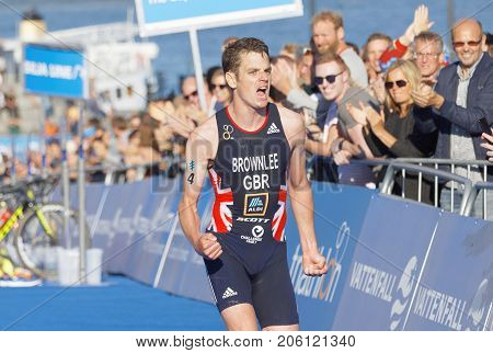 STOCKHOLM - AUG 26 2017: Running triathletes Jonathan Brownlee realize he is going to win the race in the Men's ITU World Triathlon series event August 26 2017 in Stockholm Sweden