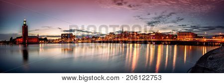 Stockholm sunset skyline with City Hall as seen from Riddarholmen. Panoramic montage from 13 images