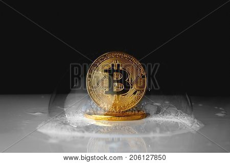 bitcoin. bitcoin in a soap bubble on black background