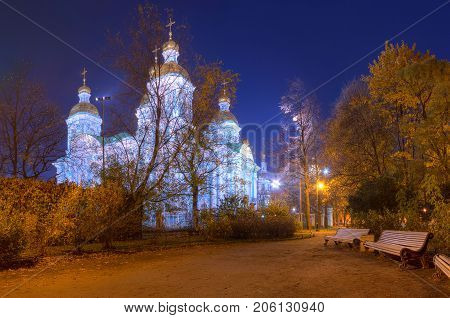 Night autumn view of illuminated St. Nicholas Naval Cathedral and alley in Nikolskiy garden St. Petersburg Russia