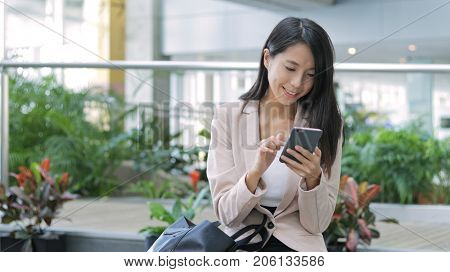 Business woman using cellphone in office 