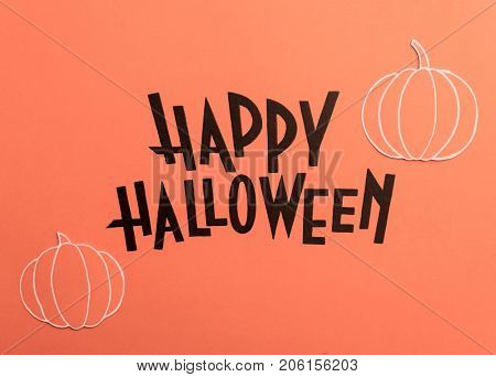 Black typeface text for halloween logo handwritten on orange background, surrounded witn pumpkins