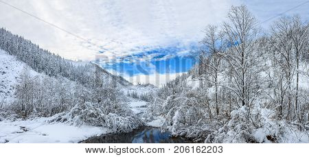 Beautiful lake Amut in taiga hills on Far East of Russia in early october. Mountain lake in winter. Beautiful nature. Snowy weather.