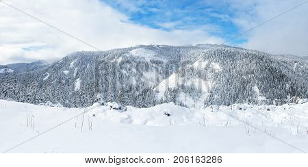 Beautiful lake Amut in taiga hills on Far East of Russia in early october. Mountain lake in winter. Beautiful nature. Snowy weather.