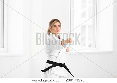 Female karate instructor training in dojo