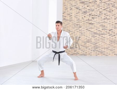 Male karate instructor training in dojo