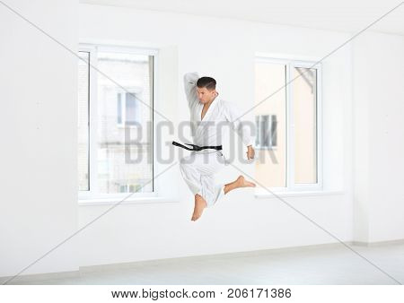 Male karate instructor training in dojo