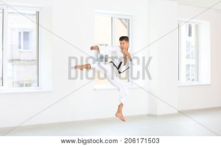 Male karate instructor training in dojo