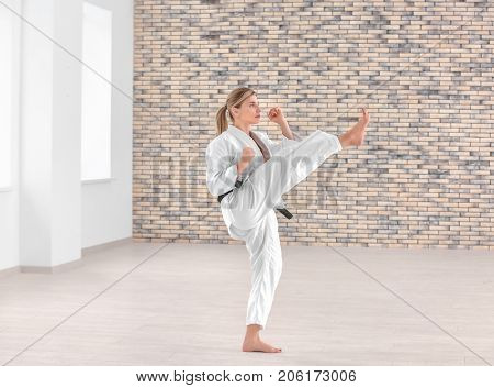 Female karate instructor training in dojo