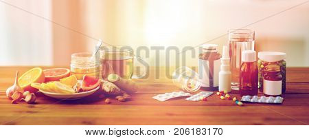 health, traditional medicine and ethnoscience concept - natural and synthetic drugs on wooden table