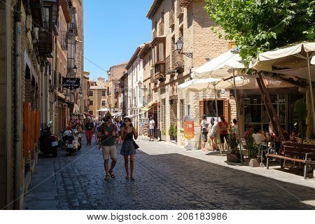 TOLEDO,SPAIN - AUGUST 8,2017 : Tourists on the medieval city of Toledo in Spain