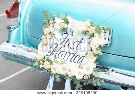 Beautiful wedding car with plate JUST MARRIED outdoors