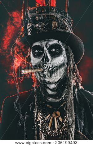 Baron Saturday. Baron Samedi. A man with a skull makeup dressed in a tail-coat and a top-hat. Dia de los muertos. Day of The Dead. Halloween.