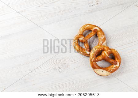 Pretzel. Beer snacks on wooden table. Top view with copy space