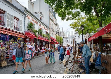 PARIS,FRANCE - JULY 31,2017 : Typical restaurants , gift shops and artists selling their paintings at the Place du Tertre in Montmartre