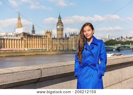 London city Europe lifestyle Asian business woman businesswoman in autumn travel holiday. Chinese businesswoman girl in stylish fall trench coat at Westminster and Big Ben.