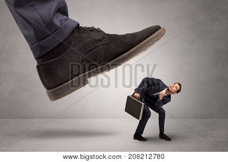 Young businessman illustrated inconsiderable by being trampled