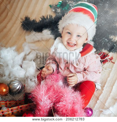 Happy Toddler Boy With A Santa Hat Looking At Camera