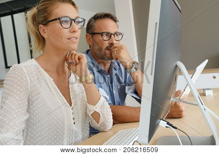 Business people working together on dektop computer