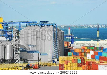 Cargo Container, Pipe And Grain Drayer In Port
