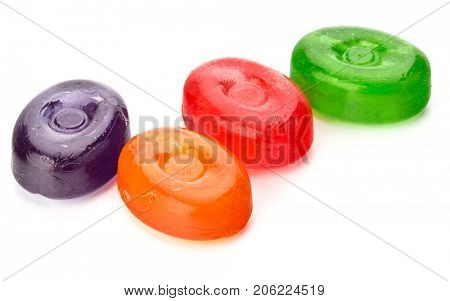 Four colorful fruit hard sugar candies,  boiled sweeties or sugar plums isolated on white background cutout