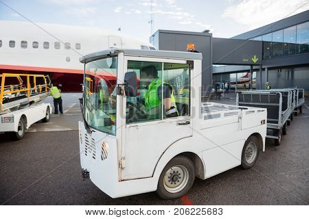 Worker Driving Vehicle On Runway