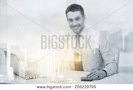 business, finances and people concept - smiling businessman with laptop computer and calculator at office over city background and double exposure effect