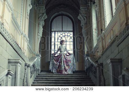 Beautiful woman standing on the top of a stairway 