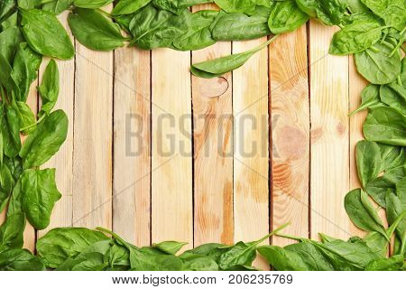 Fresh spinach leaves on wooden background