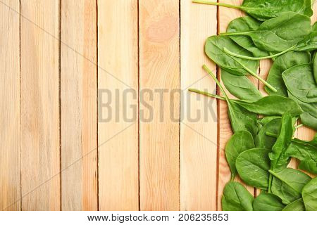 Fresh spinach leaves on wooden background