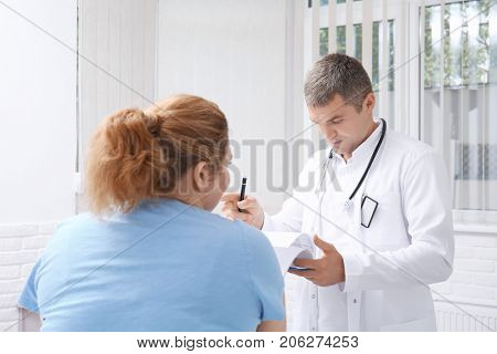 Overweight woman discussing test results with doctor in hospital